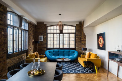 Photo of a large urban open plan living room in London with multi-coloured walls, dark hardwood flooring, brown floors and brick walls.