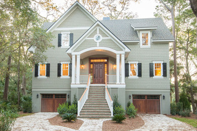 This is an example of a mid-sized transitional three-storey grey house exterior in Charleston with wood siding, a gable roof, a shingle roof and a grey roof.