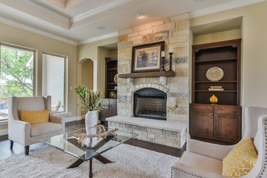 Family room - mid-sized transitional open concept dark wood floor and brown floor family room idea in Austin with beige walls, a standard fireplace, a stone fireplace and a wall-mounted tv