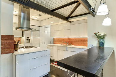 Enclosed kitchen - mid-sized contemporary u-shaped cement tile floor and gray floor enclosed kitchen idea in New York with a farmhouse sink, flat-panel cabinets, white cabinets, solid surface countertops, red backsplash, travertine backsplash, white appliances and a peninsula