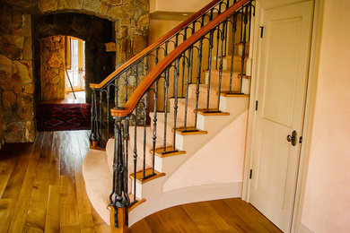 Example of a mid-sized mountain style wooden curved mixed material railing staircase design in Boston with wooden risers