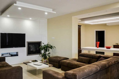 Example of a large trendy open concept porcelain tile family room design in Other with beige walls, a standard fireplace and a media wall