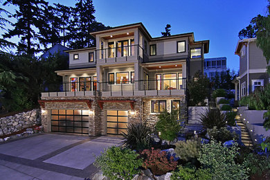Photo of an expansive contemporary three-storey grey exterior in Seattle with mixed siding and a flat roof.