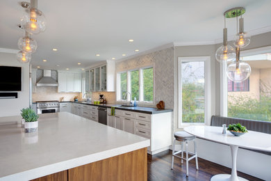 Eat-in kitchen - large transitional dark wood floor eat-in kitchen idea in San Francisco with an undermount sink, shaker cabinets, white cabinets, quartzite countertops, multicolored backsplash, stone tile backsplash, stainless steel appliances and an island
