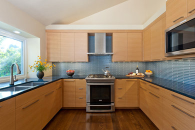 Trendy u-shaped eat-in kitchen photo in San Francisco with an undermount sink, flat-panel cabinets, medium tone wood cabinets, quartzite countertops, blue backsplash and stainless steel appliances
