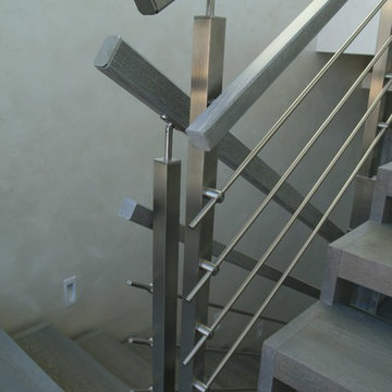 Modern metal stair covered by patina oak