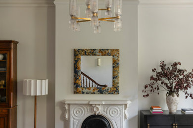 Example of a large classic formal and open concept medium tone wood floor and brown floor living room design in Chicago with white walls, a standard fireplace, a stone fireplace and no tv