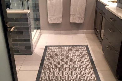 Transitional subway tile alcove shower photo in Other with medium tone wood cabinets, a two-piece toilet, beige walls, an undermount sink and marble countertops