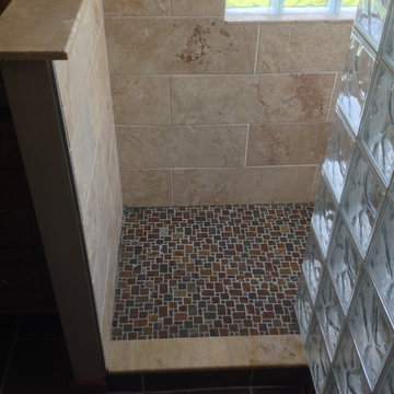 Glass block shower with a tile and stone base