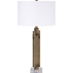 Renwil - Renwil Gabriel Antique Brass, Clear Iron, Acrylic Table Lamp - The striking profile of this modern table lamp takes its structural cues from metropolitan skyscrapers. An accent light fixture for an end table, console or desk, the clear acrylic pedestal and metal base features individual columns of forged iron that wrap around the rectangular pillar in an offset pattern that emphasizes its vertical design lines. The contemporary table lamp is finished with an antique bronze patina and topped with an off-white cotton drum lampshade.