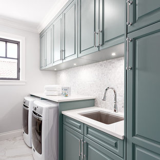 Medium sized classic single-wall separated utility room in Vancouver with a submerged sink, raised-panel cabinets, turquoise cabinets, white walls, a side by side washer and dryer and white floors.