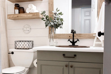Example of a farmhouse single-sink and shiplap wall bathroom design in Los Angeles with a one-piece toilet and a drop-in sink