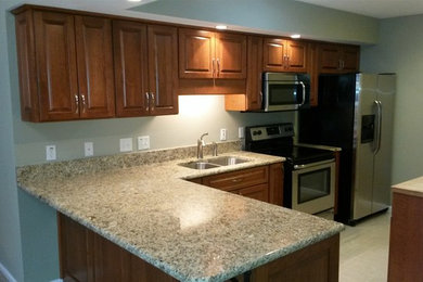 Eat-in kitchen - mid-sized traditional l-shaped eat-in kitchen idea in Other with an undermount sink, light wood cabinets, stainless steel appliances and an island