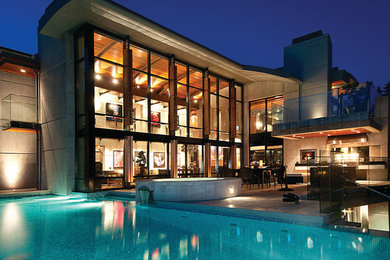 Inspiration for a large modern gray two-story concrete exterior home remodel in Vancouver