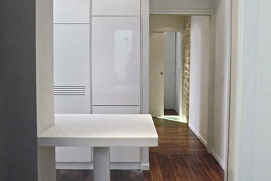 Design ideas for a modern u-shaped kitchen in London with flat-panel cabinets, white cabinets and laminate benchtops.