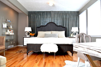 Inspiration for a large master bedroom in Hawaii with grey walls, medium hardwood floors and no fireplace.