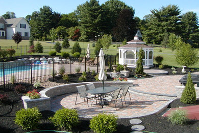 Inspiration for a large timeless backyard concrete paver patio remodel in Philadelphia
