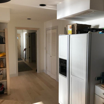 Existing view from kitchen back toward open hallway and archway to main foyer.