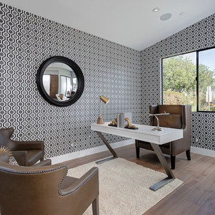 Design ideas for a medium sized modern study in Los Angeles with multi-coloured walls, light hardwood flooring, no fireplace and a freestanding desk.