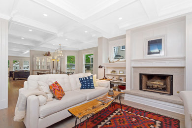 Living room - large country medium tone wood floor, brown floor and coffered ceiling living room idea in Chicago with a standard fireplace and a stone fireplace