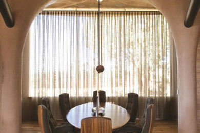 Example of a mid-sized trendy medium tone wood floor great room design in Albuquerque with beige walls and no fireplace