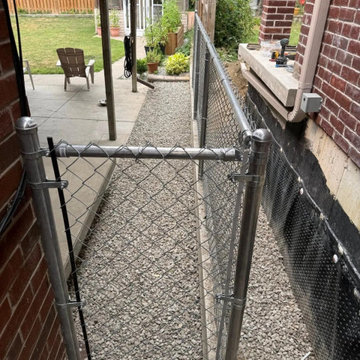 Chain link gate at the patio end of the Mississauga side yard run
