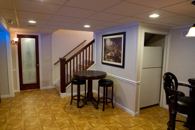 Mid-sized minimalist basement photo in Kansas City with beige walls