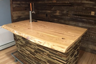 Home bar - contemporary home bar idea in New York with wood countertops
