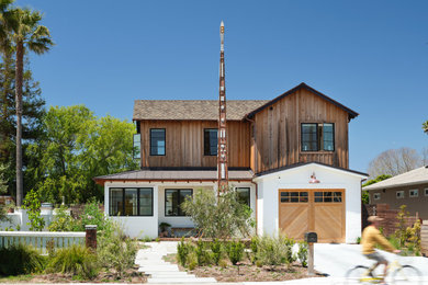 Coastal two-story wood and board and batten house exterior idea in San Francisco with a mixed material roof