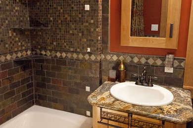 Bathroom - traditional multicolored tile bathroom idea in Denver with a drop-in sink, recessed-panel cabinets, medium tone wood cabinets and granite countertops