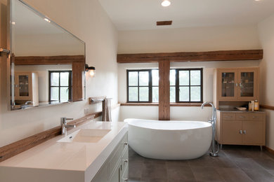 Freestanding bathtub - rustic master stone tile porcelain tile and brown floor freestanding bathtub idea in Other with furniture-like cabinets, light wood cabinets, white walls, an integrated sink and solid surface countertops