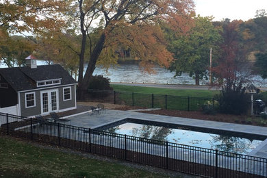 Inspiration for a mid-sized timeless side yard concrete paver and rectangular lap pool remodel in Boston