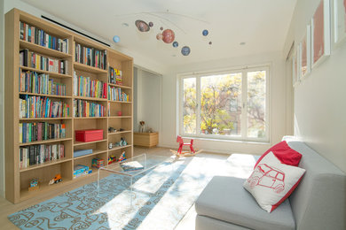 Large contemporary gender-neutral kids' room in New York with white walls and light hardwood floors.