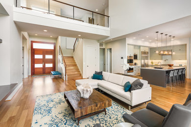 Living room - huge contemporary loft-style medium tone wood floor living room idea in Seattle with white walls