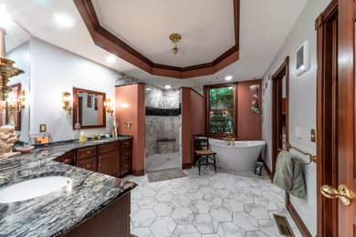 Bathroom - master porcelain tile, white floor and double-sink bathroom idea in Columbus with brown cabinets, an undermount sink, quartz countertops and a built-in vanity