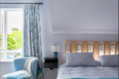 Пример оригинального дизайна: хозяйская спальня среднего размера: освещение в современном стиле с синими стенами, полом из винила и коричневым полом