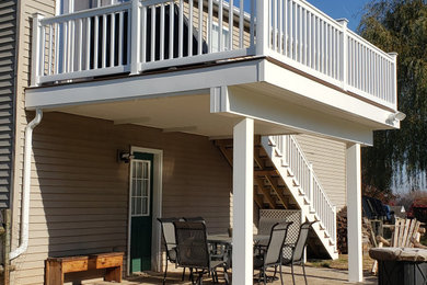 Modelo de terraza contemporánea de tamaño medio sin cubierta en patio trasero con barandilla de varios materiales