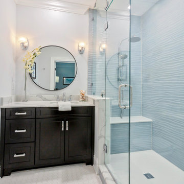 Compact Luxury Bathroom with Wavy Tile and Dark Vanity