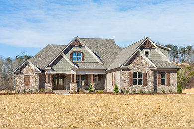 Large arts and crafts beige two-story mixed siding exterior home photo in Other with a hip roof