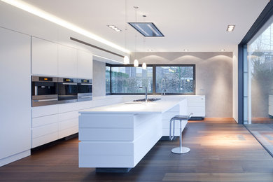 Design ideas for a large contemporary l-shaped open plan kitchen in Hanover with an undermount sink, flat-panel cabinets, white cabinets, solid surface benchtops, grey splashback, white appliances, dark hardwood floors, with island and brown floor.