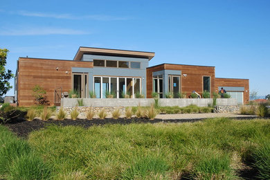 Example of a minimalist one-story mixed siding flat roof design in San Francisco