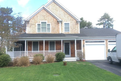 Example of a beach style two-story wood exterior home design in Other with a shingle roof