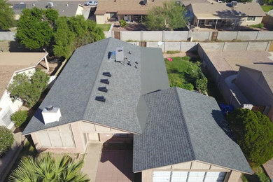 Inspiration for a mid-sized timeless beige two-story brick exterior home remodel in Phoenix with a shingle roof