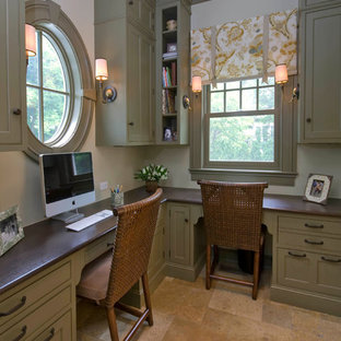 Photo of a mid-sized traditional study room in Chicago with a built-in desk, beige walls, limestone floors, no fireplace and brown floor.