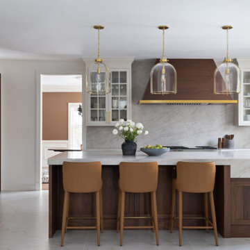 Custom Walnut and White Kitchen Remodel with Marble Slab Backsplash and Brass Ac
