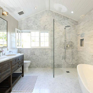 Inspiration for a transitional bathroom remodel in Los Angeles with an undermount sink, furniture-like cabinets, dark wood cabinets and a two-piece toilet