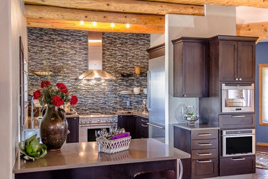 Inspiration for a small transitional u-shaped brick floor enclosed kitchen remodel in Orange County with a farmhouse sink, shaker cabinets, black cabinets, multicolored backsplash, ceramic backsplash, stainless steel appliances and a peninsula