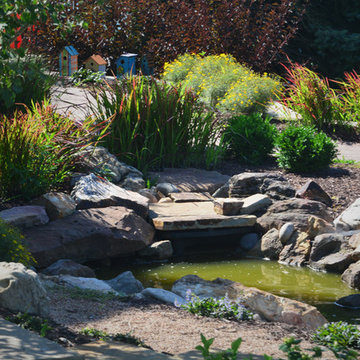 Rustic Mountain stream flowing into lakeside patio