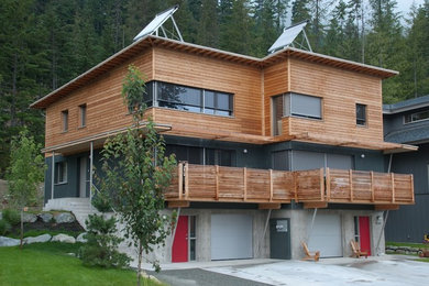 Example of a minimalist brown two-story wood exterior home design in Vancouver