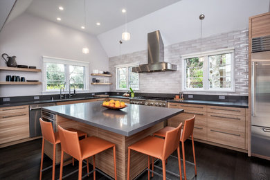 Design ideas for a large modern l-shaped eat-in kitchen in San Francisco with an undermount sink, flat-panel cabinets, light wood cabinets, stainless steel appliances, dark hardwood floors, with island, quartz benchtops, grey splashback, porcelain splashback and brown floor.